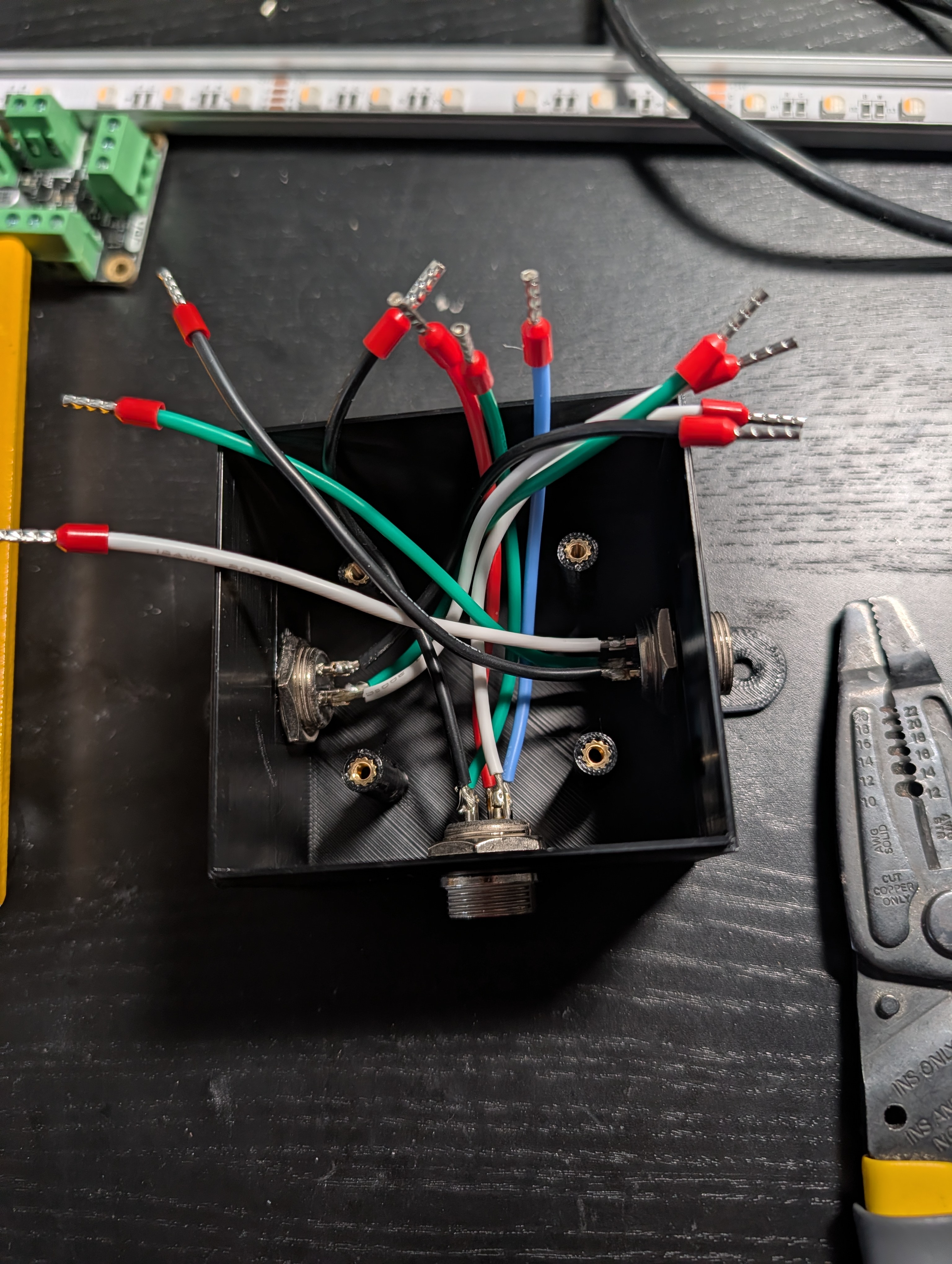 One enclosure showing three connectors on the sides, each with loose wires