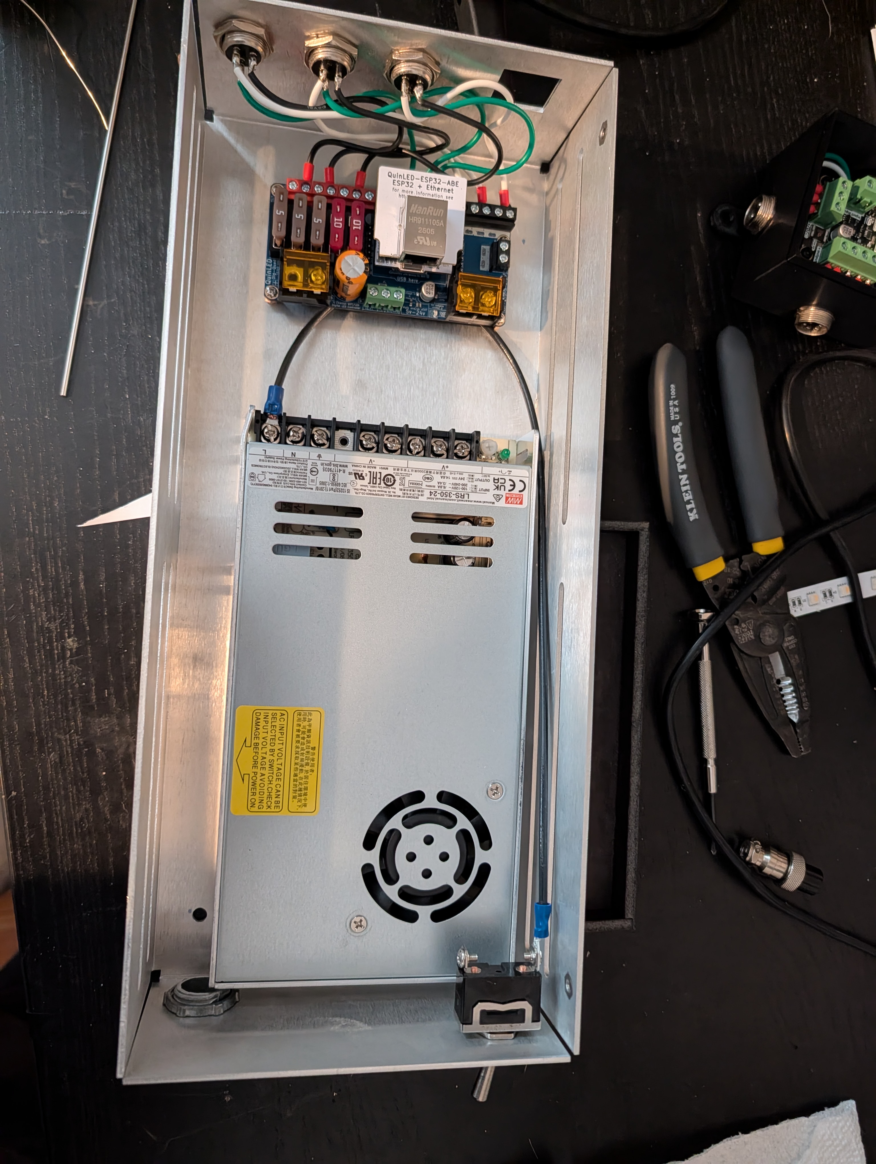 A metal enclosure with a power supply and control board mounted inside it